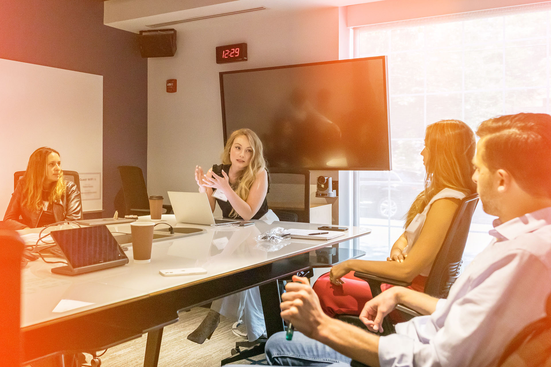 A woman leading a discussion with a group of people.