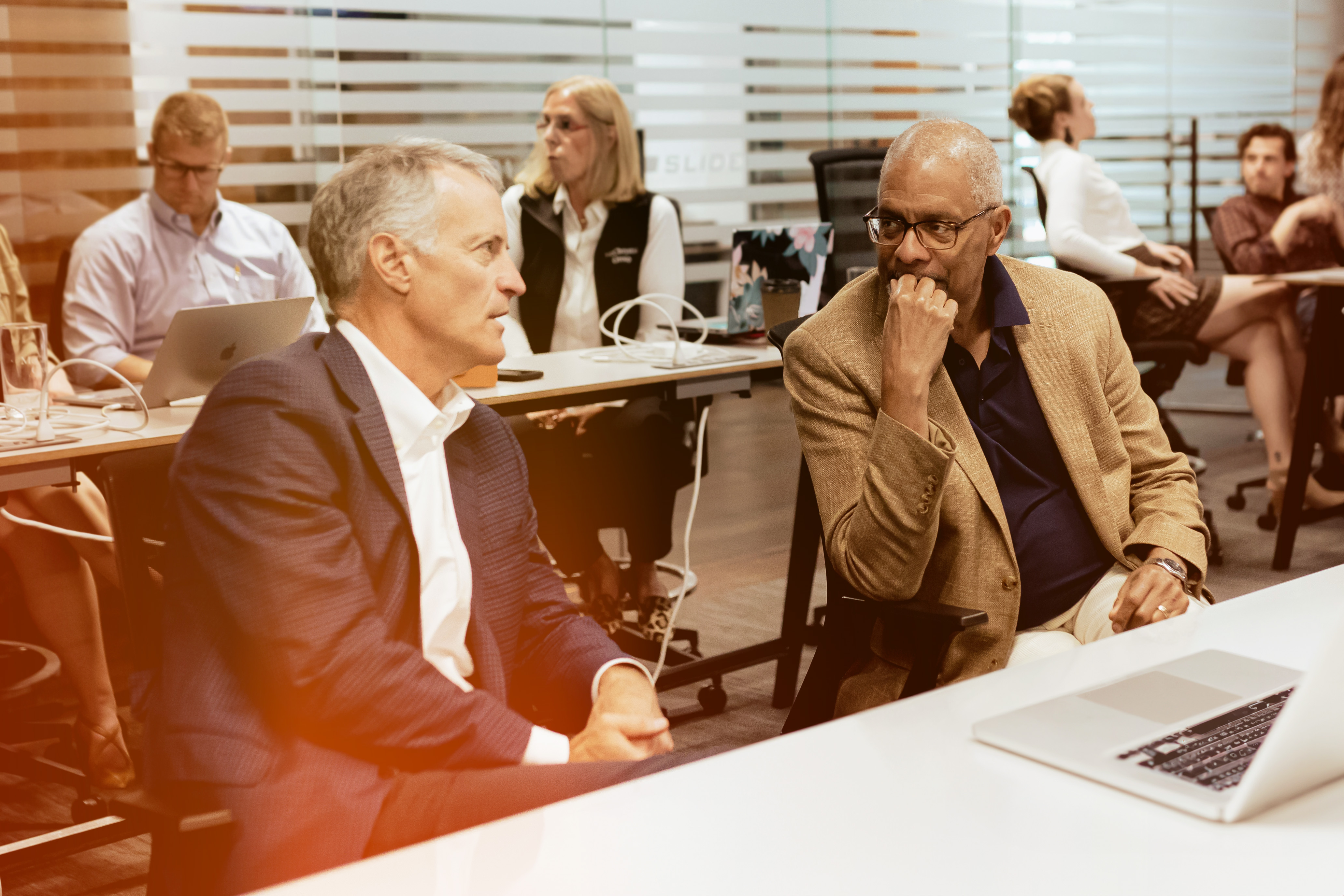 Employees in Conversation Sitting at Tables