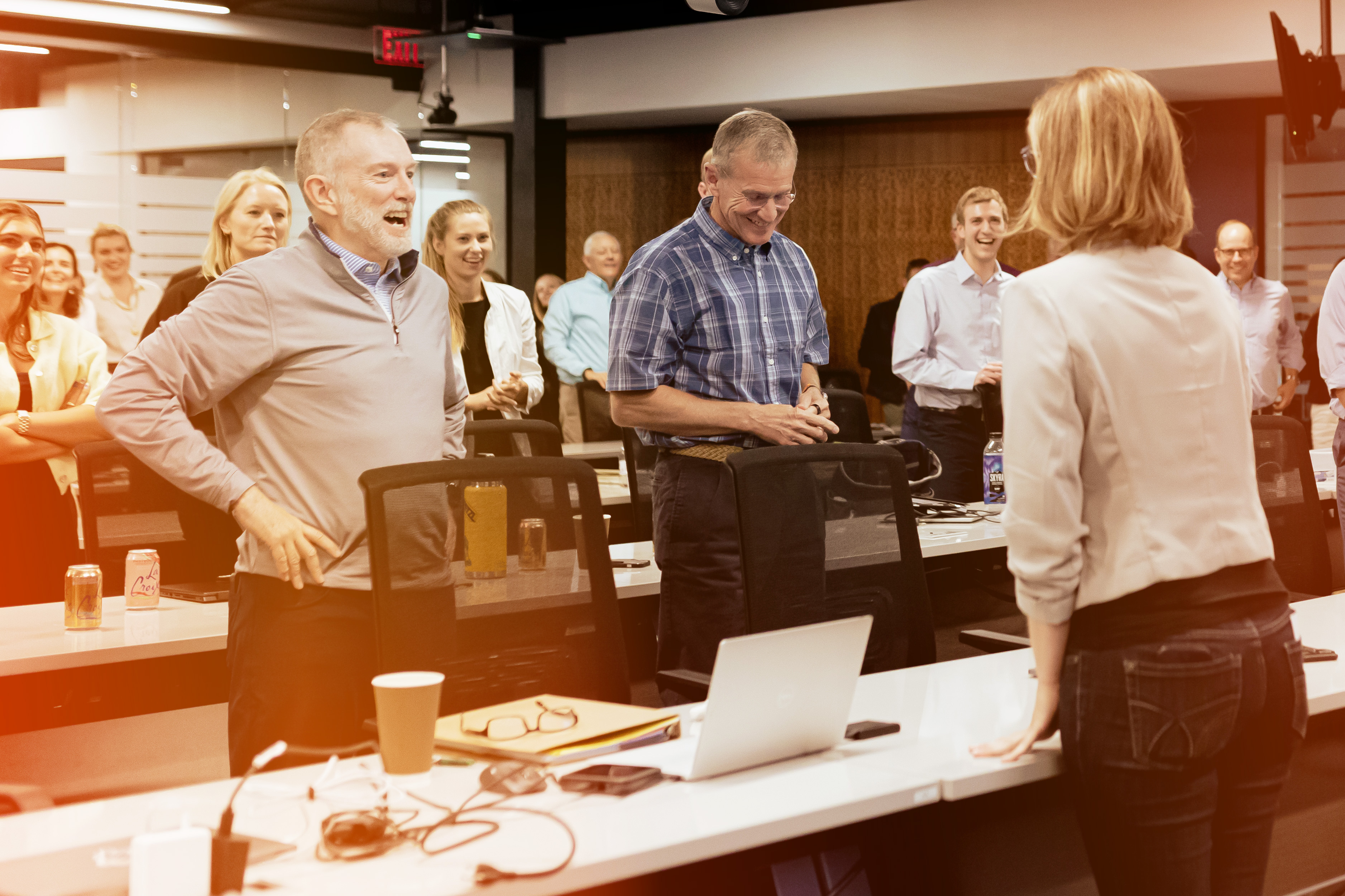 Colleagues Standing in a Room Smiling