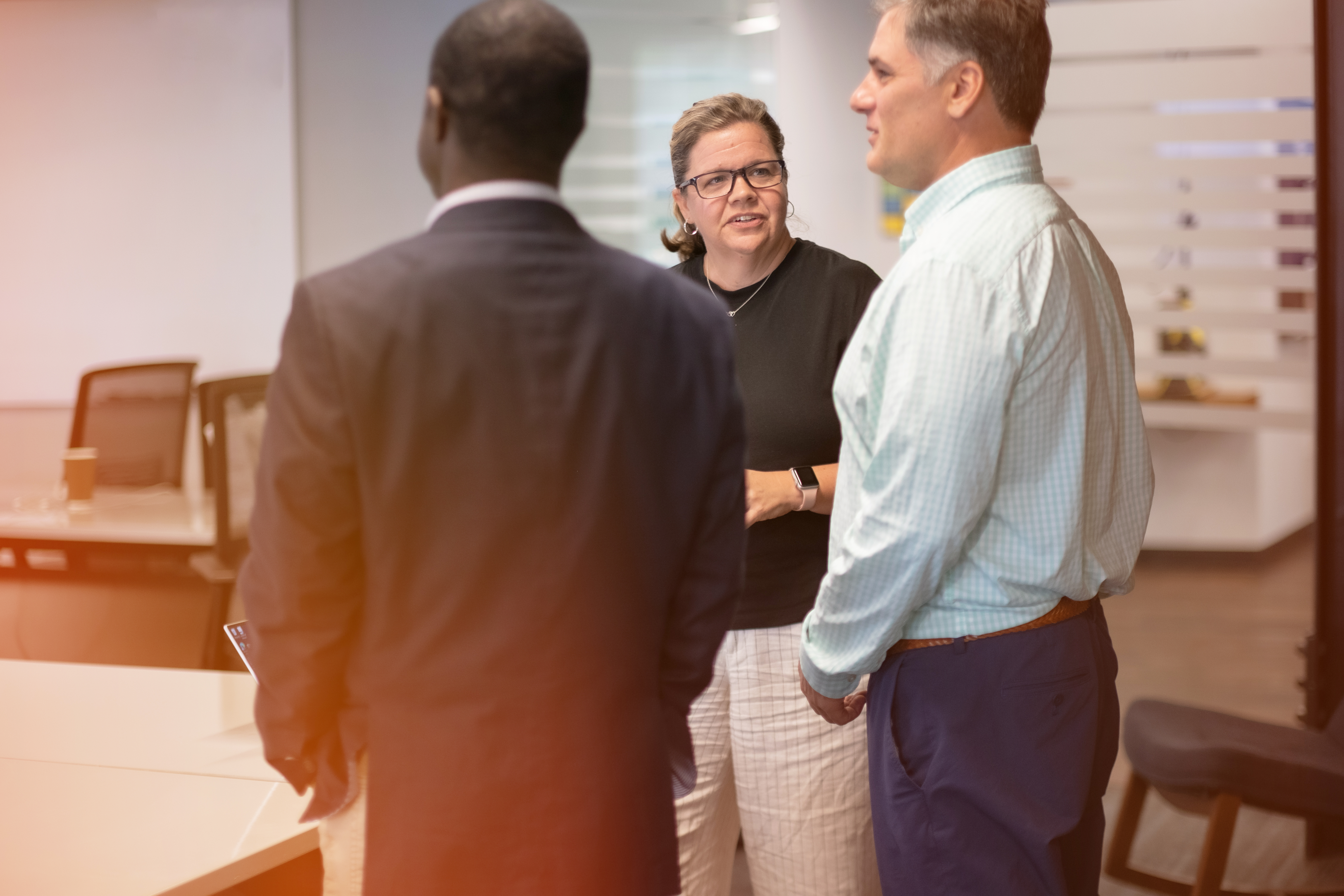 Three colleagues discussing work